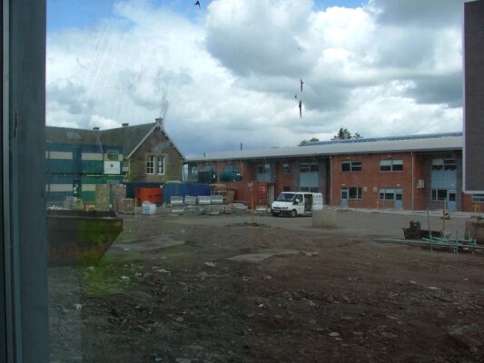 View through a new window across the muddy building site to Auchterarder Community School next door.