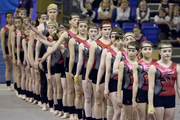 Auchterarder gymnasts in matching red and black leotards lined up on the floor before their 2012 display routine