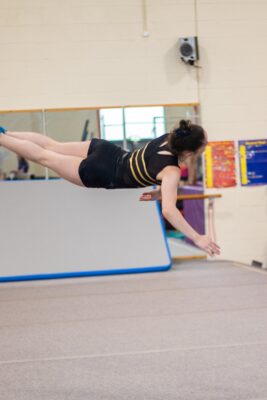 Gymnast horizontal in mid-air during a dive drill
